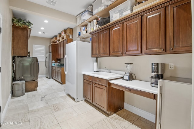 kitchen featuring stainless steel fridge, white refrigerator, and sink