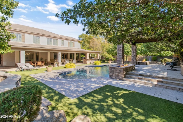 view of swimming pool featuring outdoor lounge area, a patio, and a lawn