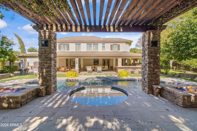 exterior space featuring a pergola, a patio area, and a swimming pool with hot tub