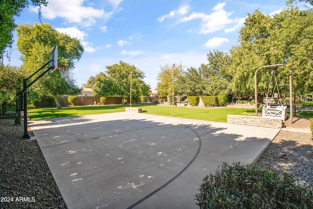 view of sport court featuring a lawn