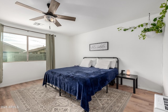 bedroom featuring hardwood / wood-style flooring and ceiling fan