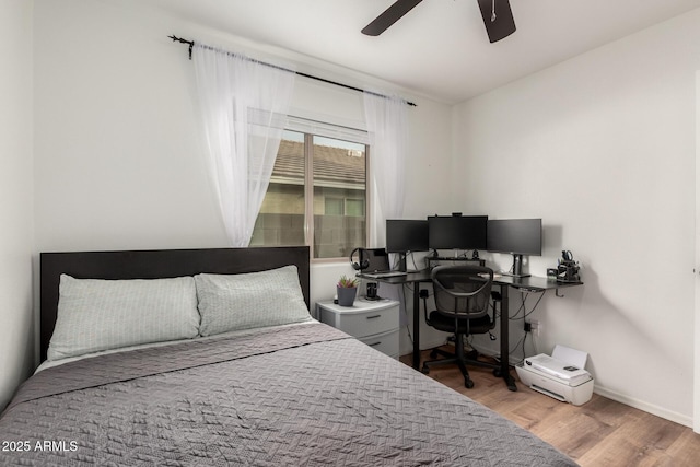 bedroom with hardwood / wood-style flooring and ceiling fan