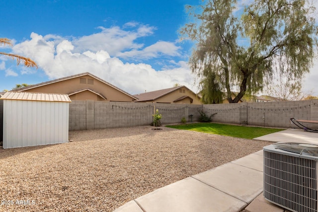 view of yard featuring a storage unit, central AC unit, and a patio