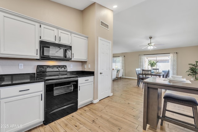 kitchen featuring ceiling fan, white cabinets, light hardwood / wood-style flooring, and black appliances