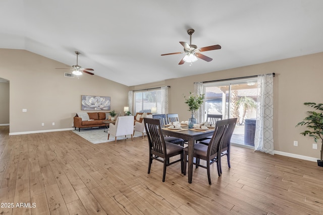 dining area with vaulted ceiling, ceiling fan, and light hardwood / wood-style flooring