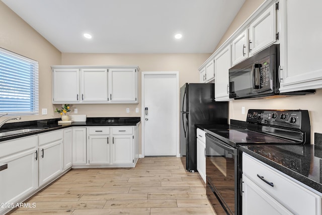 kitchen with white cabinetry, sink, and black appliances