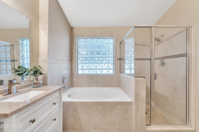 bathroom with vanity, vaulted ceiling, and shower with separate bathtub