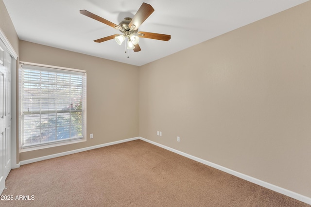 empty room with ceiling fan and carpet flooring