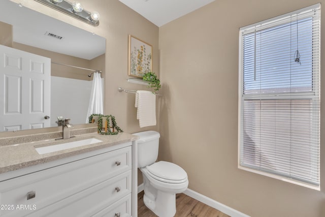 bathroom featuring vanity, wood-type flooring, toilet, and a shower with curtain