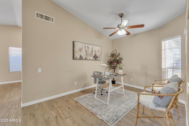 home office featuring ceiling fan, vaulted ceiling, and light hardwood / wood-style flooring