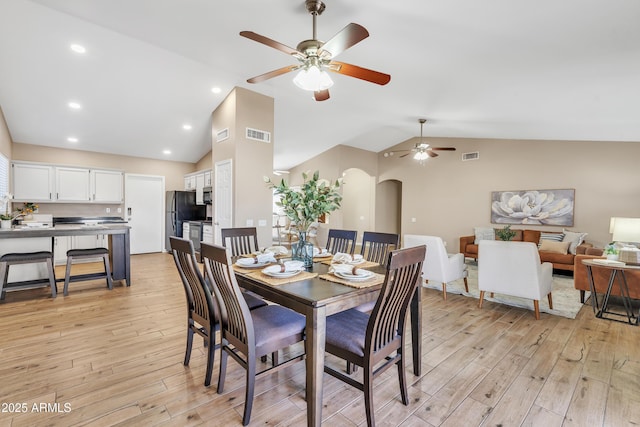 dining room with lofted ceiling and light hardwood / wood-style floors