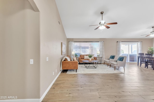 living room featuring ceiling fan and light hardwood / wood-style flooring