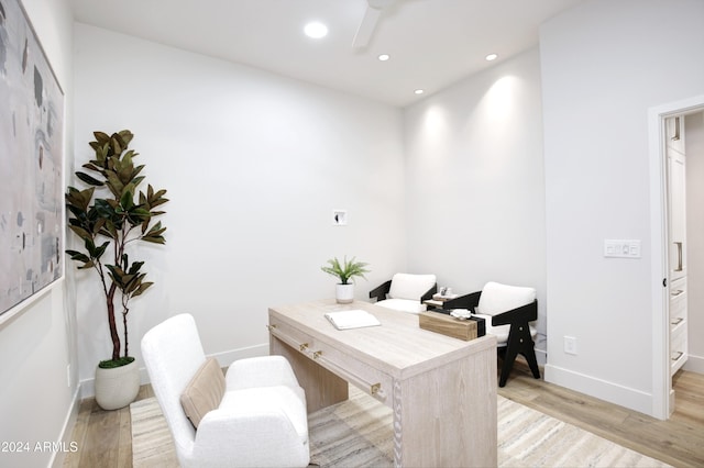 office space featuring ceiling fan and light hardwood / wood-style flooring