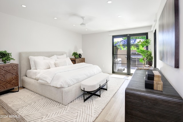 bedroom with ceiling fan, light hardwood / wood-style floors, access to exterior, and french doors