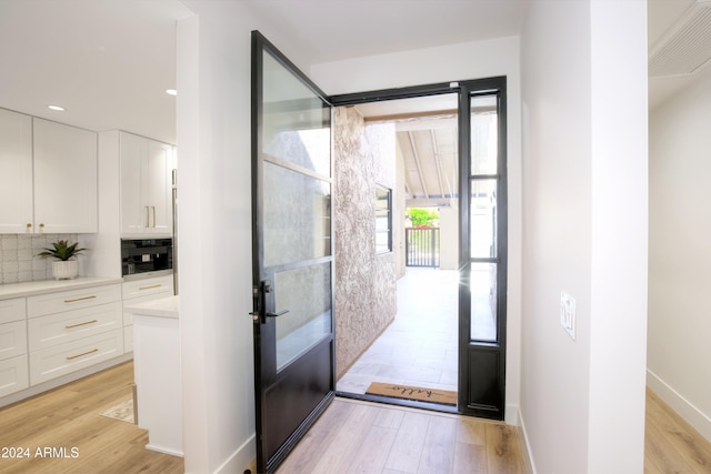 doorway with light hardwood / wood-style flooring