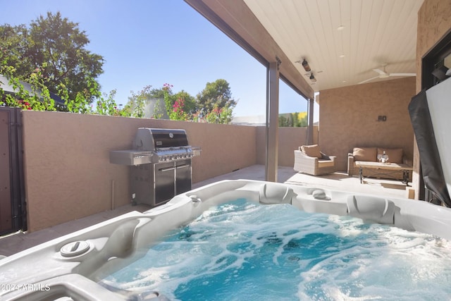 view of patio with a hot tub, grilling area, and ceiling fan