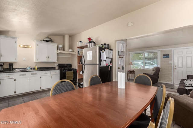 tiled dining room with a sink