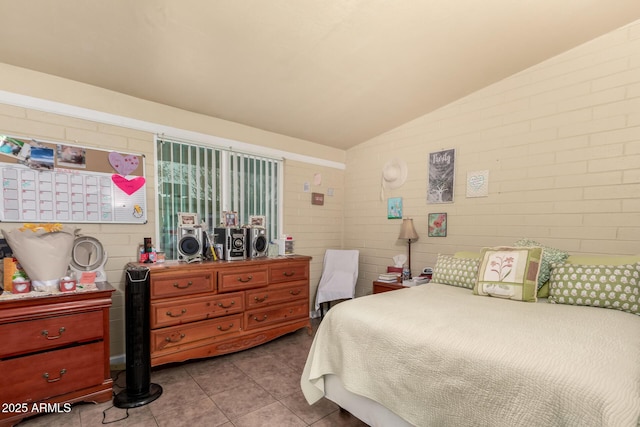 bedroom with vaulted ceiling and tile patterned floors