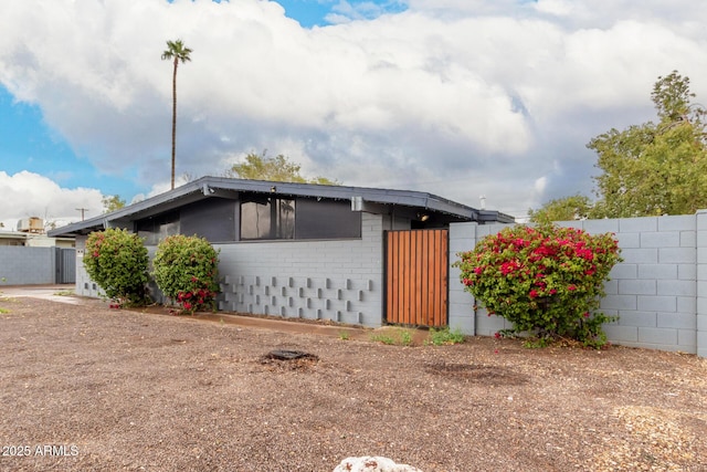 exterior space with fence and brick siding