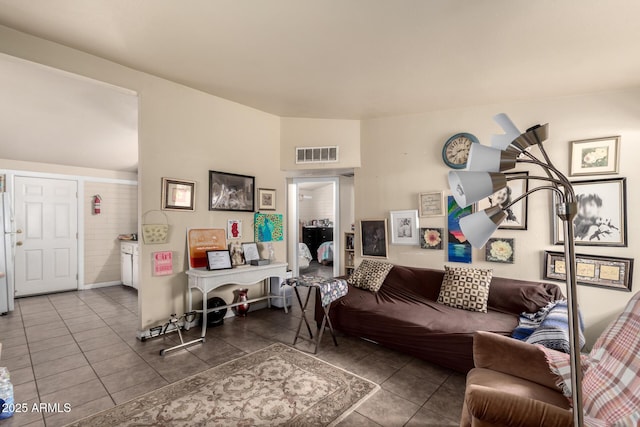 living area with tile patterned floors and visible vents