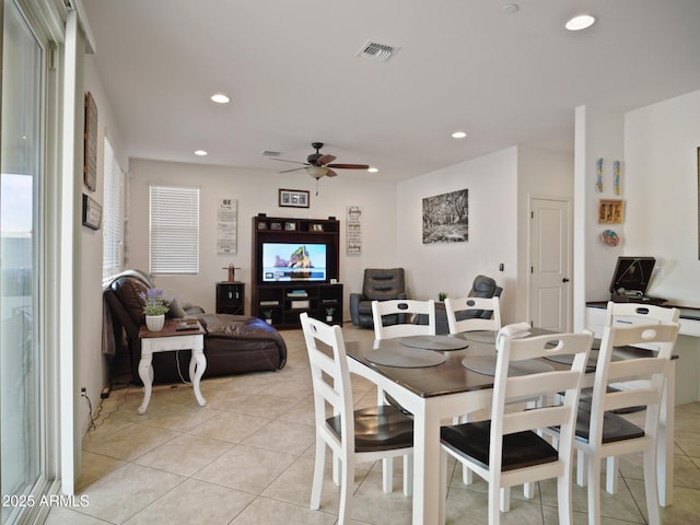 tiled dining area with ceiling fan