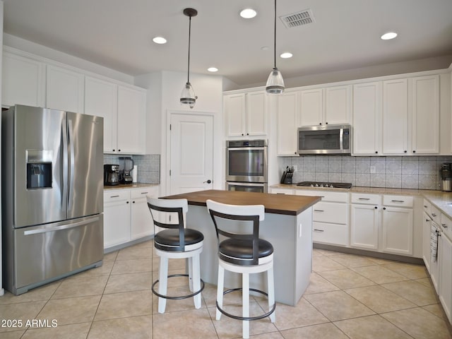 kitchen featuring stainless steel appliances and white cabinets