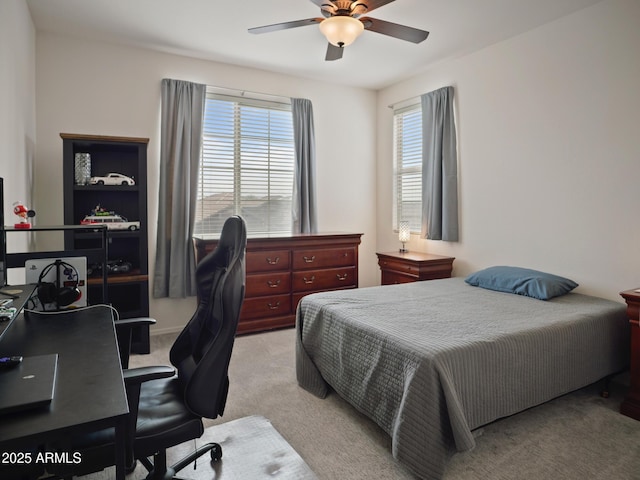 bedroom with ceiling fan and light carpet