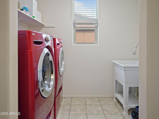 laundry area featuring light tile patterned flooring and independent washer and dryer