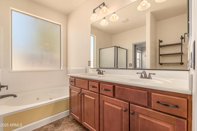 full bath with a jetted tub, double vanity, an enclosed shower, and a sink