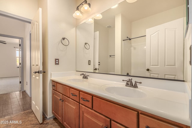 full bathroom with double vanity and a sink