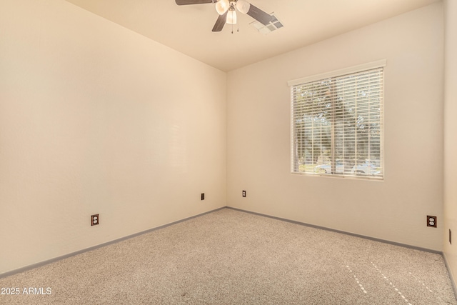 carpeted spare room with baseboards and a ceiling fan