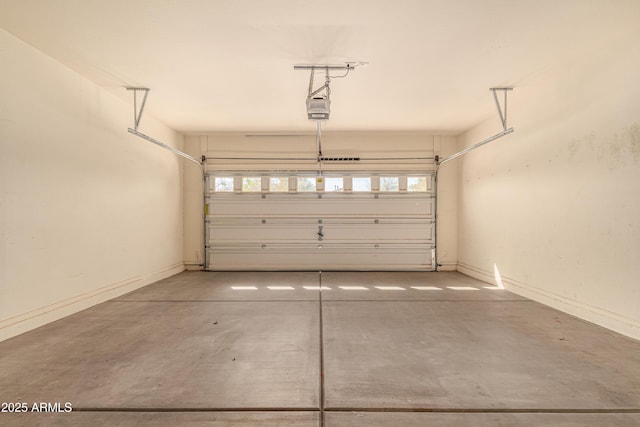 garage with a garage door opener and baseboards