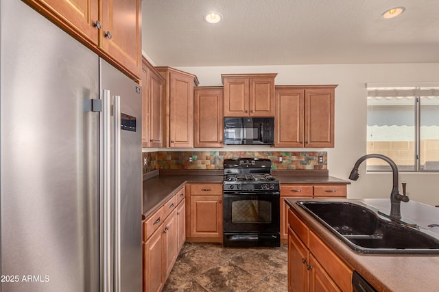 kitchen with tasteful backsplash, dark countertops, a sink, and black appliances