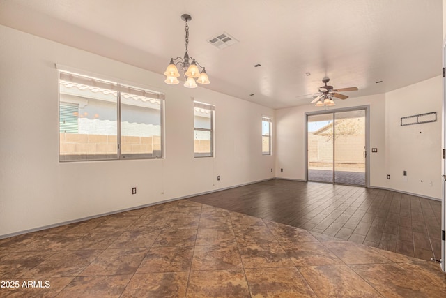 empty room featuring ceiling fan with notable chandelier, wood finished floors, visible vents, and baseboards