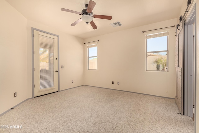 unfurnished bedroom with baseboards, visible vents, ceiling fan, and carpet flooring