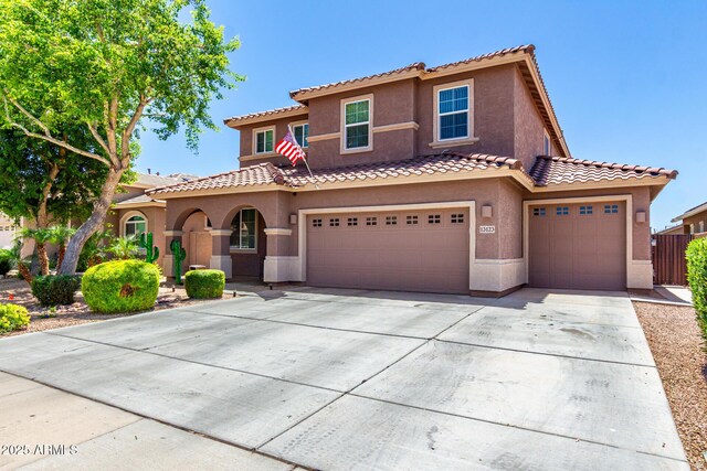 13123 W Cottontail Ln, Peoria, AZ 85383 - mediterranean / spanish-style home featuring stucco siding, concrete driveway, an attached garage, and a tiled roof
