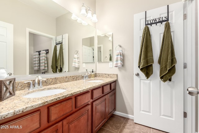 13123 W Cottontail Ln, Peoria, AZ 85383 - bathroom with tile patterned floors, double vanity, and baseboards