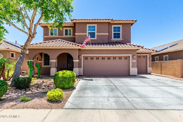 13123 W Cottontail Ln, Peoria, AZ 85383 - mediterranean / spanish home with concrete driveway, stucco siding, fence, an attached garage, and a tiled roof