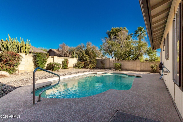 view of swimming pool featuring a patio area