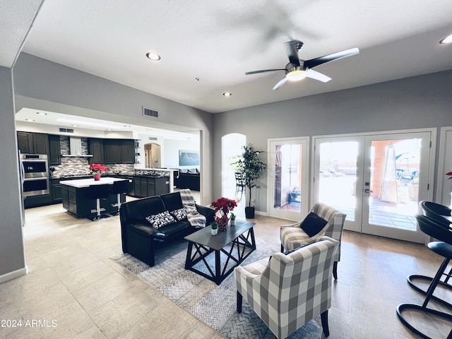 living room featuring french doors and ceiling fan