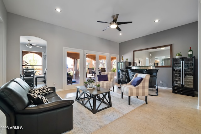 living room featuring beverage cooler, ceiling fan, and french doors