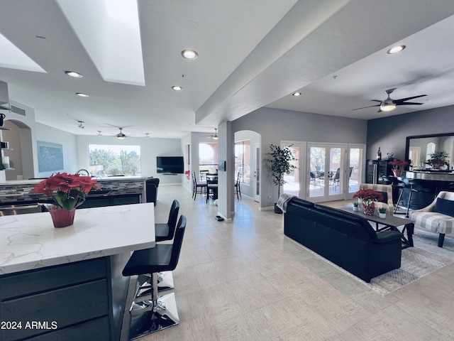 living room with ceiling fan and french doors