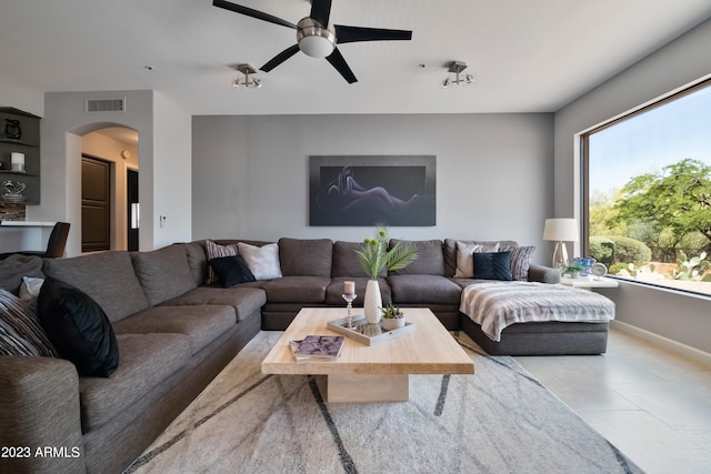 living room with ceiling fan and a healthy amount of sunlight