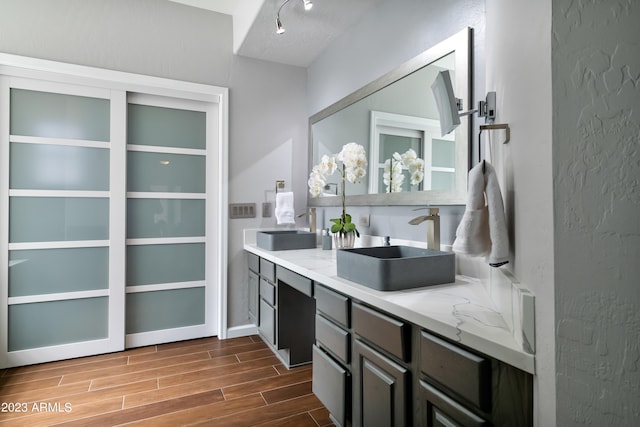 bar featuring light stone countertops and sink