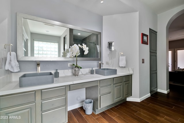 bathroom featuring walk in shower and vanity