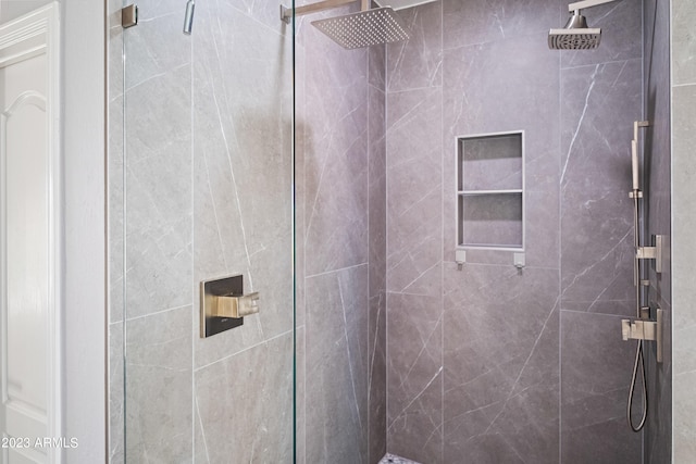 bathroom with a shower with shower door