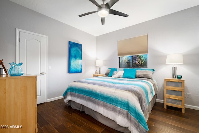 bedroom with dark hardwood / wood-style flooring and ceiling fan