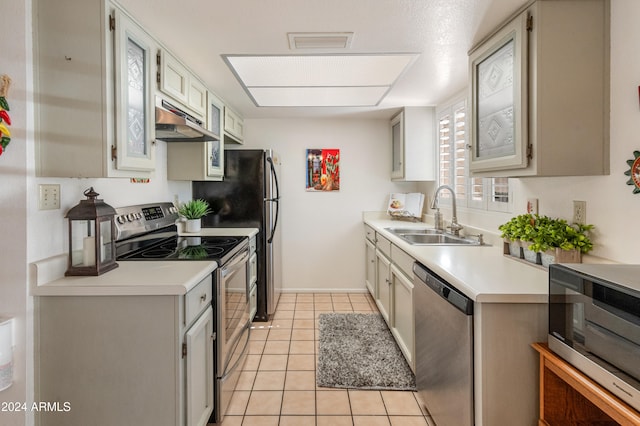 kitchen featuring light tile patterned flooring, appliances with stainless steel finishes, and sink