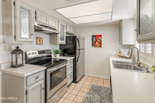 kitchen with white cabinetry, stainless steel appliances, sink, and light tile patterned floors