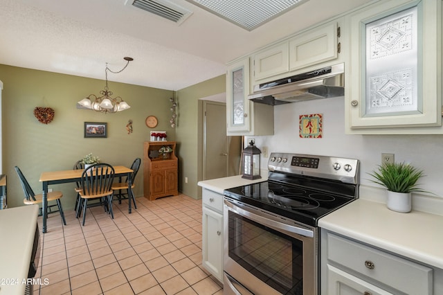 kitchen with stainless steel electric stove, light tile patterned flooring, decorative light fixtures, a chandelier, and white cabinets